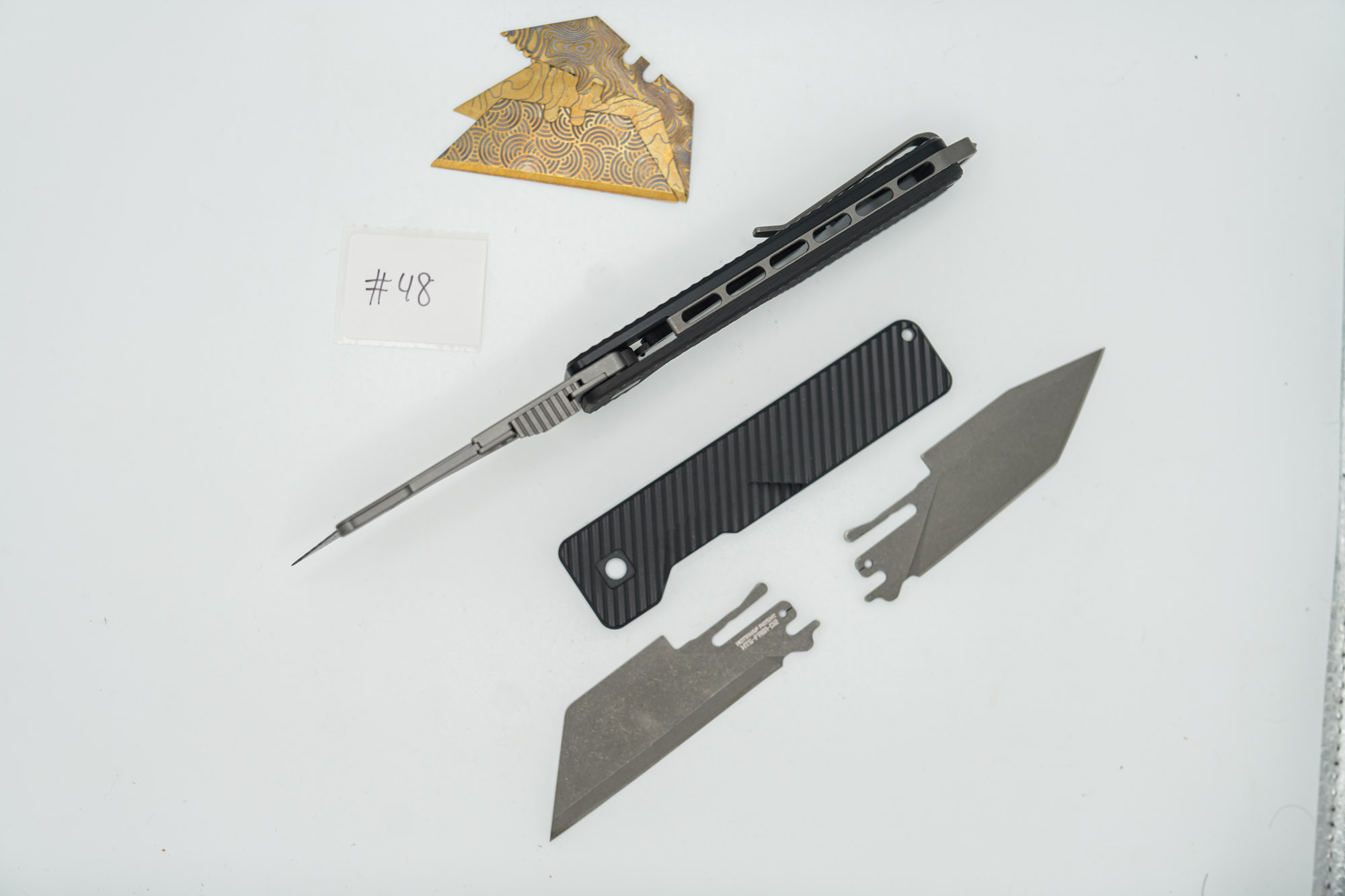 BUILD #48 Combo — Condition 10/10 — TiRant ULTRA Carbon Fiber USA-Milled Deep Slash RH Scale + Jet-Black PVD Deep Slash LH Scale + Original Deep Slash RH Ti Black PVD Scale + Installed Skeleton Glass-Breaker Rear Spacer + 4X Custom Laser Engraved Razor Blades + D2 Full-Razor Style Hotswap Blade + Half Tanto Topo Lasered Blem Blade - Image 8